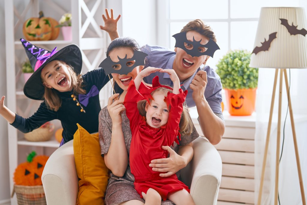 Aqua Springs dental in san marcos texas Avoid Candy Overload this Halloween It's that time of year again! Time to take the kids to a fall festival or even go door to door trick or treating around the neighborhood. Every year it's the one night that children get to dress as their favorite superhero, princess, or other character and have a ton of fun doing it. In other words, Halloween is a fun night for all. However, as a parent concerned about your child's dental health, you know that all of that fun (and the pile of candy that goes along with it) can be detrimental to your child's oral health. family celebrating Halloween